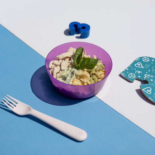 Purple bowl with salad on a blue and white background